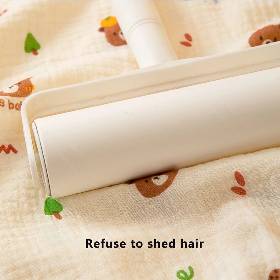 Roll of white fabric with cartoon bear pattern on a beige background