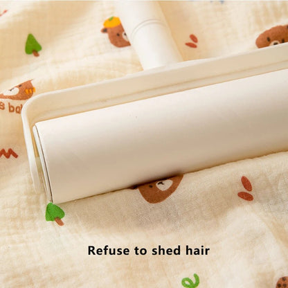 Roll of white fabric with cartoon bear pattern on a beige background