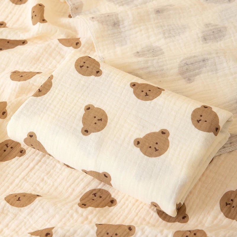 White pillow with brown bear patterns on a beige fabric background