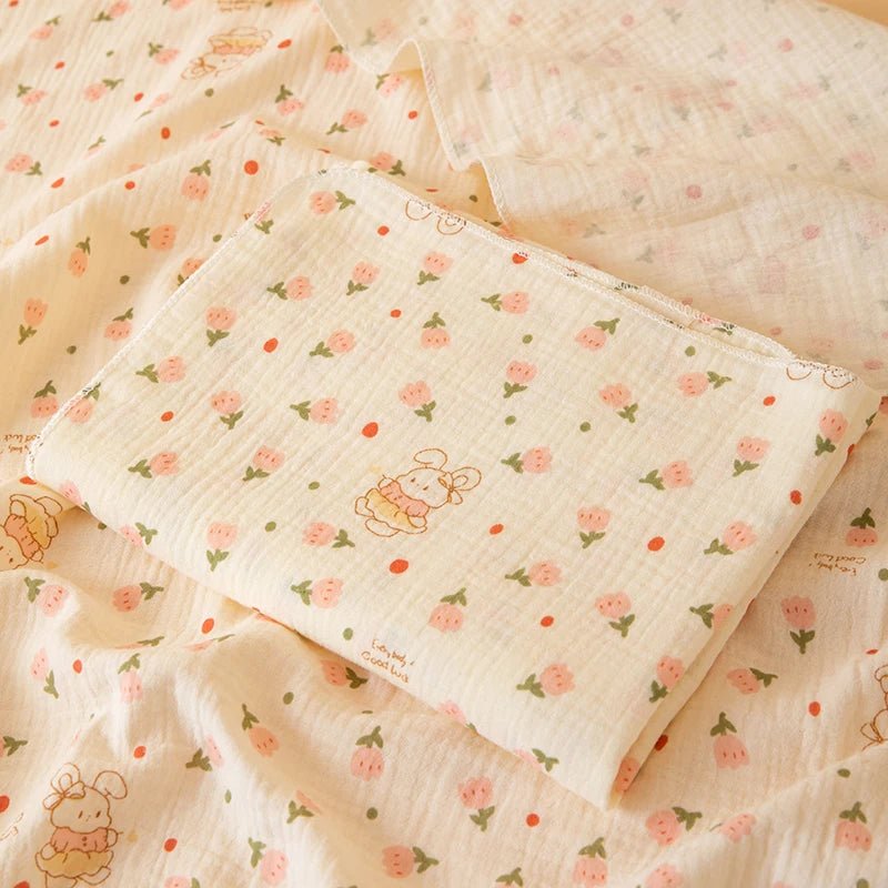 Floral patterned fabric with cartoon character on a matching blanket