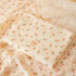 Floral patterned fabric with cartoon character on a matching blanket
