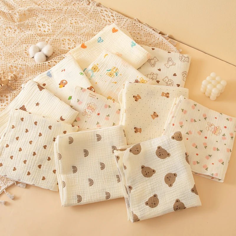 Collection of baby blankets with various patterns on a beige surface