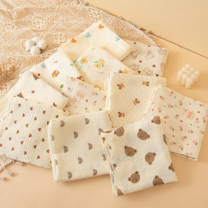Collection of baby blankets with various patterns on a beige surface