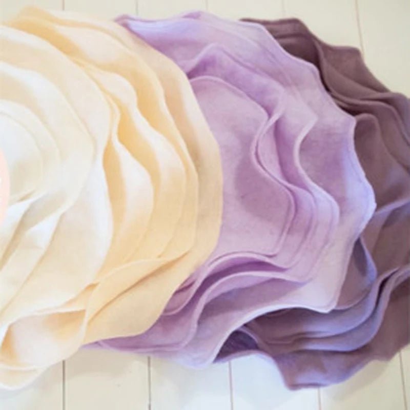 Stack of colorful fabric swatches on a light wooden surface