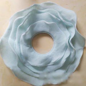 Light blue flower-shaped object on a beige background