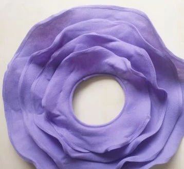Purple fabric flower on a white background