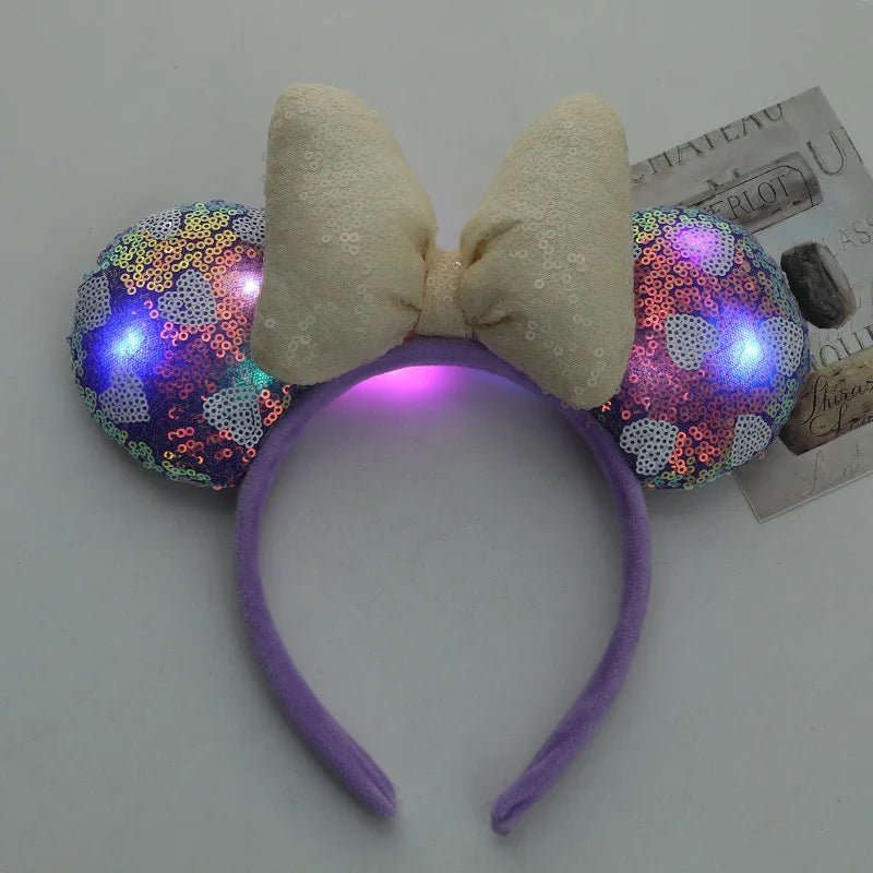 Purple headband with LED light-up ears and bow on a white background
