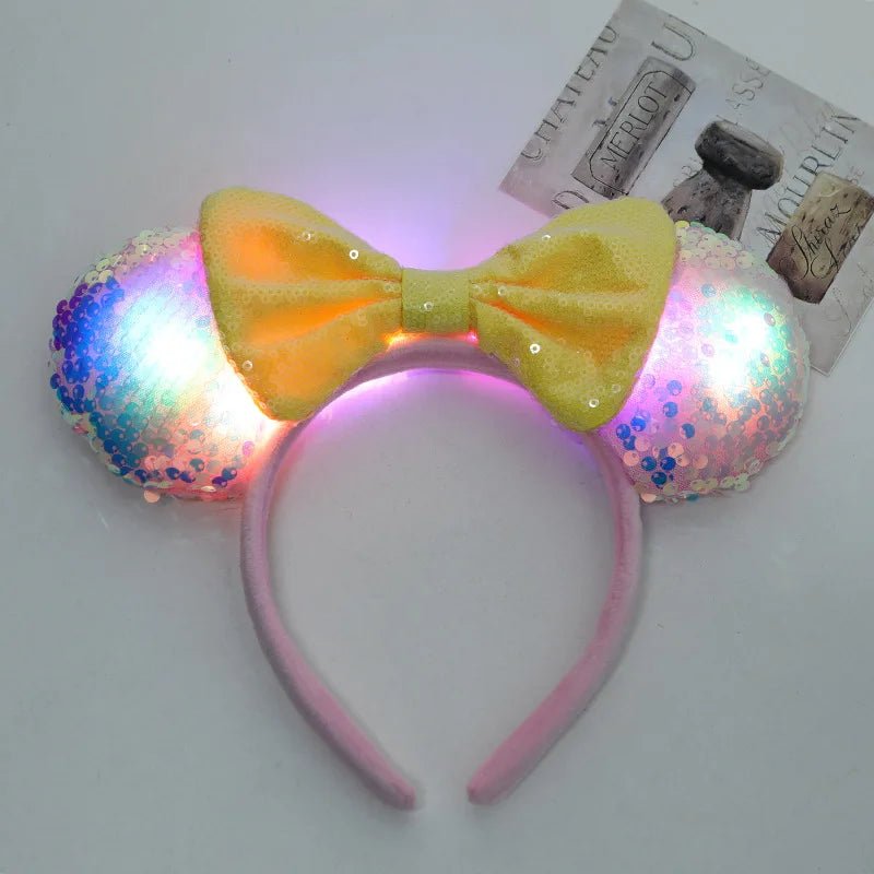 Luminous headband with colorful LED lights and a yellow bow on a light gray background.