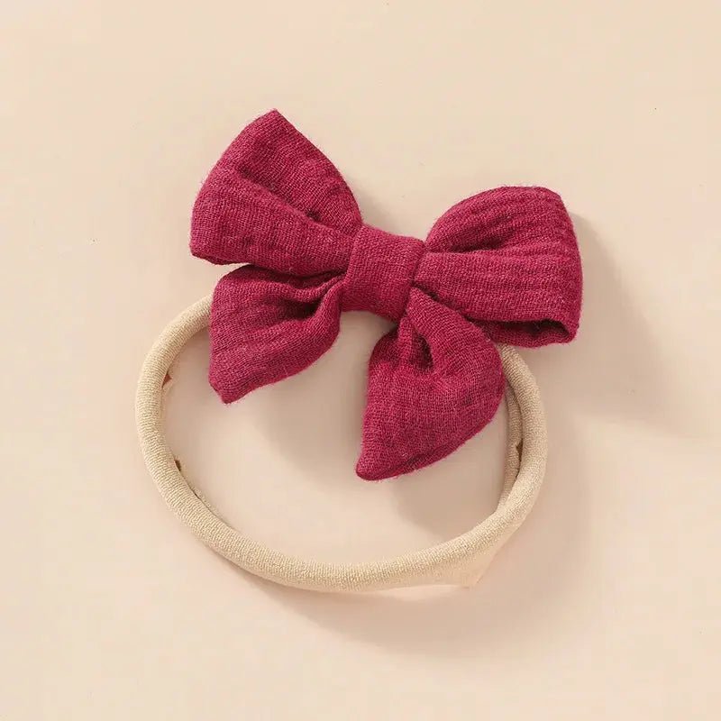 Red bow headband on a beige background