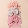 Pink headband with decorative elements on a light background