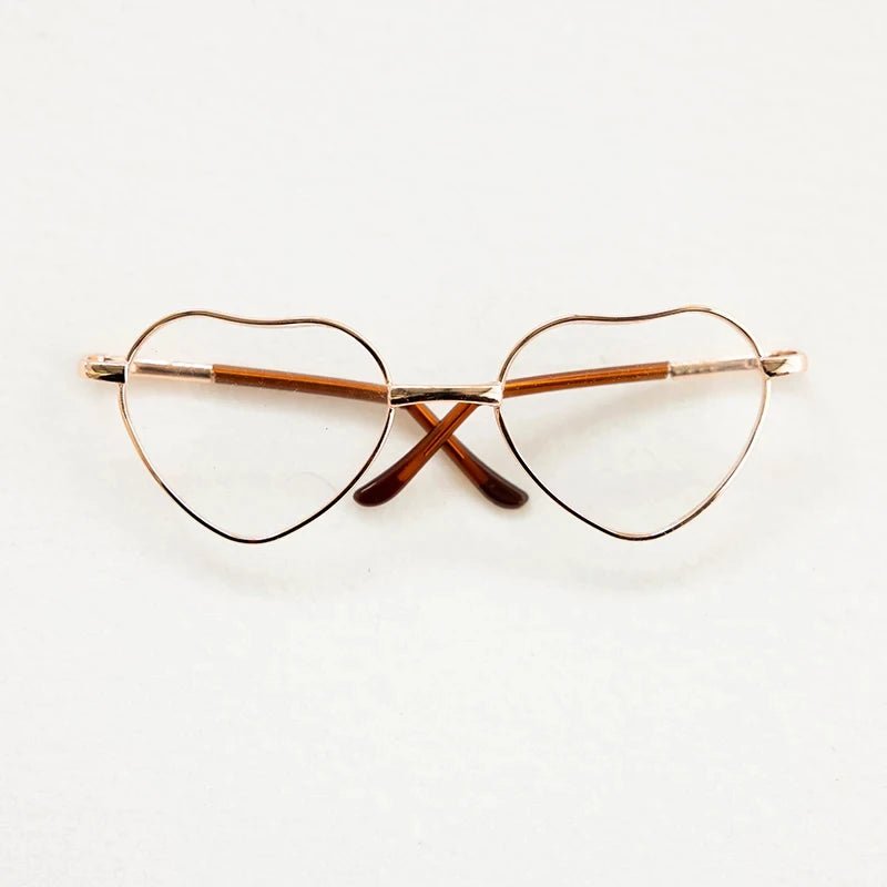 Heart-shaped eyeglasses with gold frame on a white background
