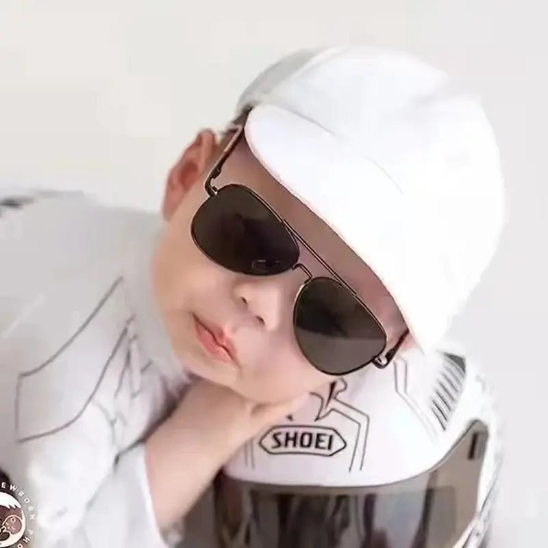 Person wearing a white SHOEI motorcycle helmet with sunglasses on a white background