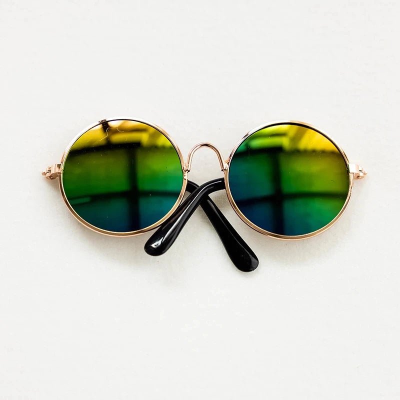 Round sunglasses with green lenses and gold frames on a white background