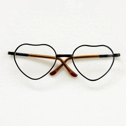 Heart-shaped eyeglasses with black frame and brown temple tips on a white background