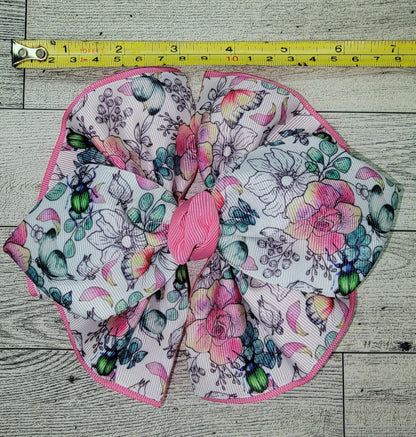 Floral fabric bow with a measuring tape on a wooden surface