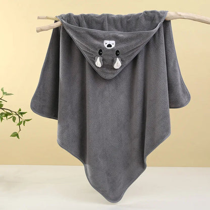 Gray hooded towel with animal face design on a wooden stick against a yellow background