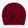 Red headband with a bow on a plain background