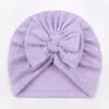 Purple headband with a bow on a plain background