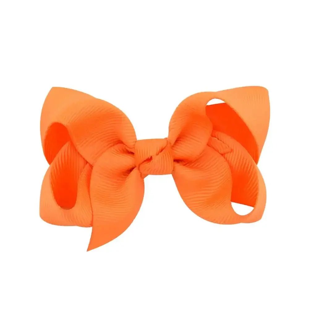 Large orange hair bow on a white background