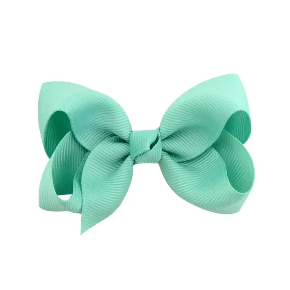 Mint green hair bow on a white background