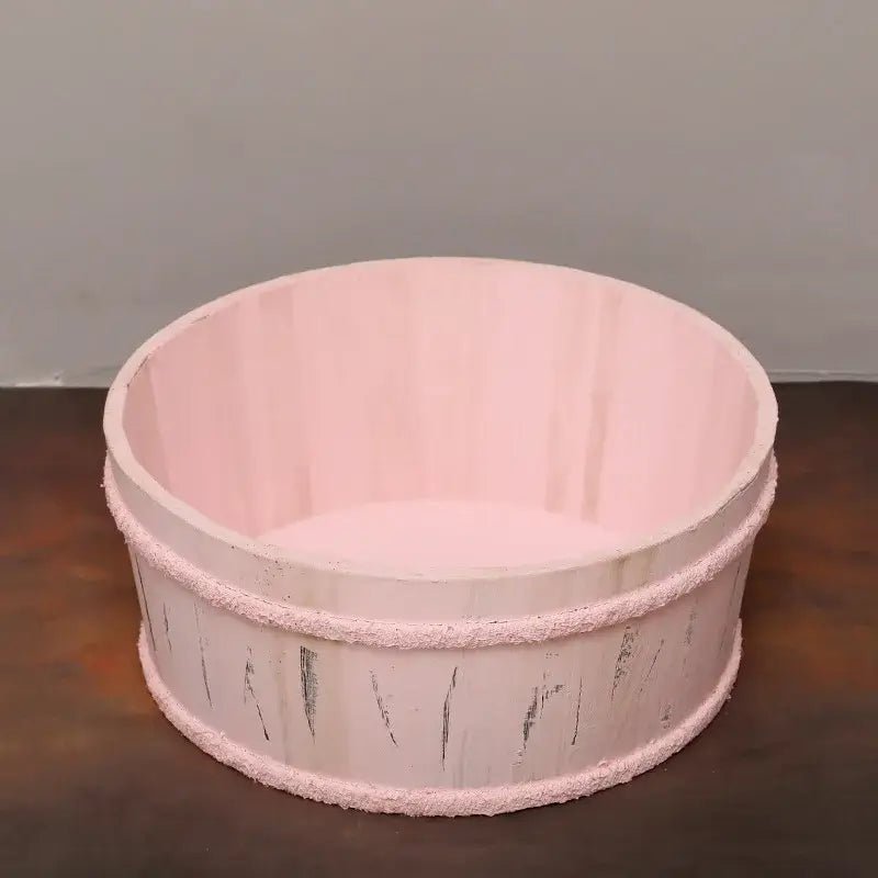 Pink wooden basket on a dark surface with a gray background